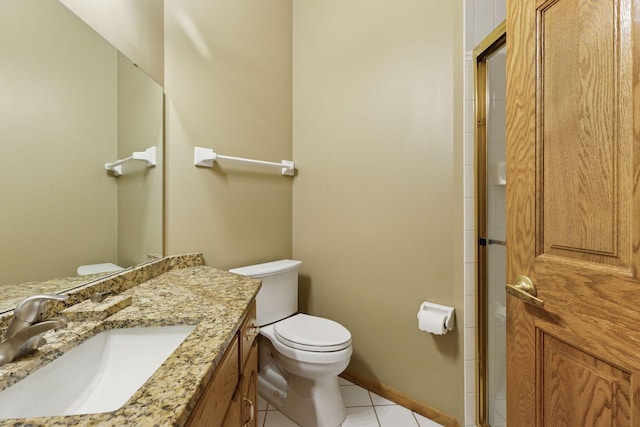 12124 Bluebird Cir NW, Coon Rapids, MN 55448 - bathroom featuring tile patterned floors, toilet, a shower with shower door, vanity, and baseboards
