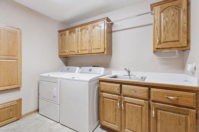 12124 Bluebird Cir NW, Coon Rapids, MN 55448 - washroom with washer and dryer, cabinet space, and a textured ceiling