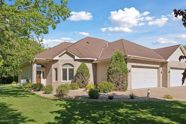 12124 Bluebird Cir NW, Coon Rapids, MN 55448 - view of front facade featuring brick siding, an attached garage, a front lawn, concrete driveway, and a shingled roof