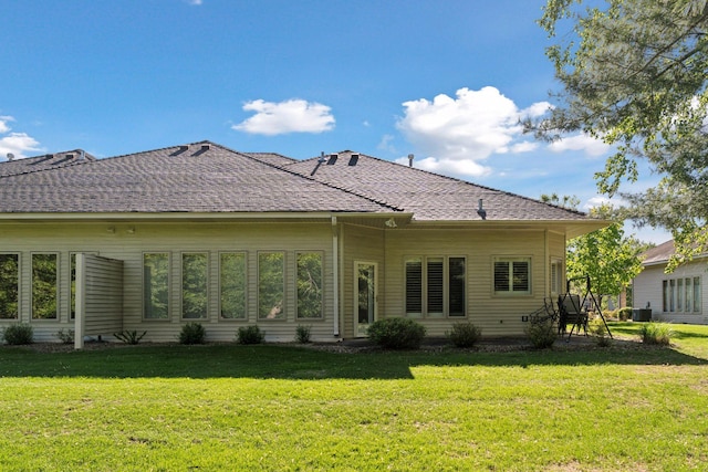 12124 Bluebird Cir NW, Coon Rapids, MN 55448 - rear view of property featuring a yard and central AC unit