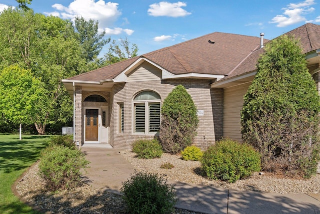 12124 Bluebird Cir NW, Coon Rapids, MN 55448 - view of front of house with brick siding, roof with shingles, and a front yard
