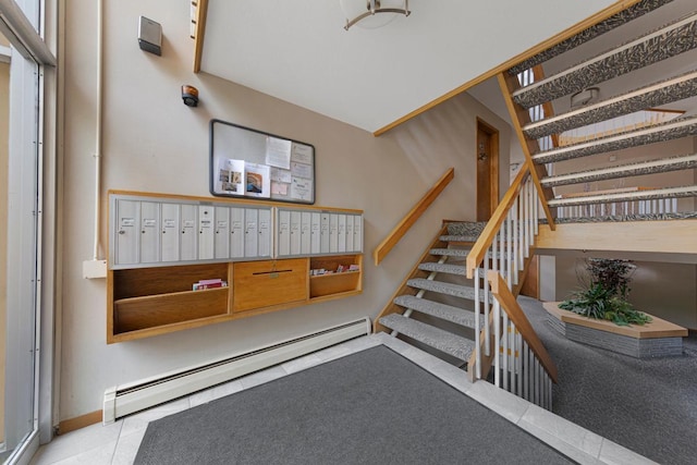5440 Three Points Blvd Unit 536, Mound, MN 55364 - stairway featuring baseboard heating, mail area, tile patterned flooring, and baseboards