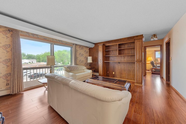 5440 Three Points Blvd Unit 536, Mound, MN 55364 - living room with wallpapered walls, a textured ceiling, wood finished floors, and healthy amount of natural light