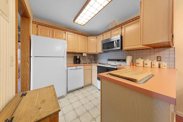 5440 Three Points Blvd Unit 536, Mound, MN 55364 - kitchen featuring white appliances, light flooring, backsplash, a sink, and light brown cabinetry