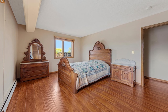 5440 Three Points Blvd Unit 536, Mound, MN 55364 - bedroom with baseboard heating, light wood-type flooring, baseboards, and beam ceiling