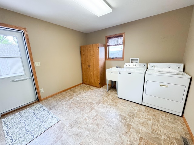 404 5th Ave, Wilmont, MN 56185 - washroom featuring separate washer and dryer, stone finish flooring, and baseboards