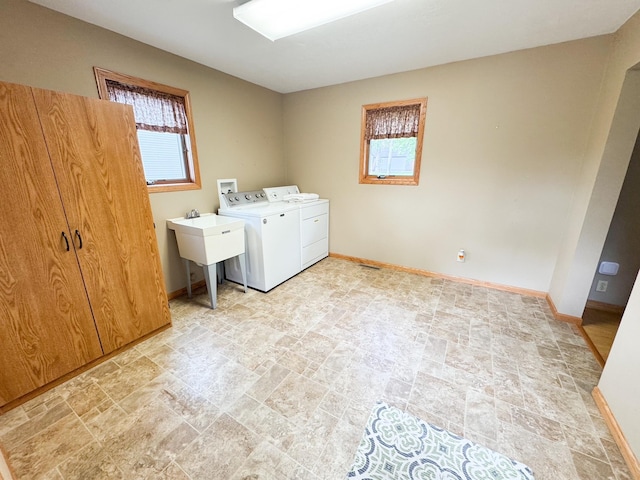 404 5th Ave, Wilmont, MN 56185 - washroom with stone finish flooring, washing machine and clothes dryer, and baseboards
