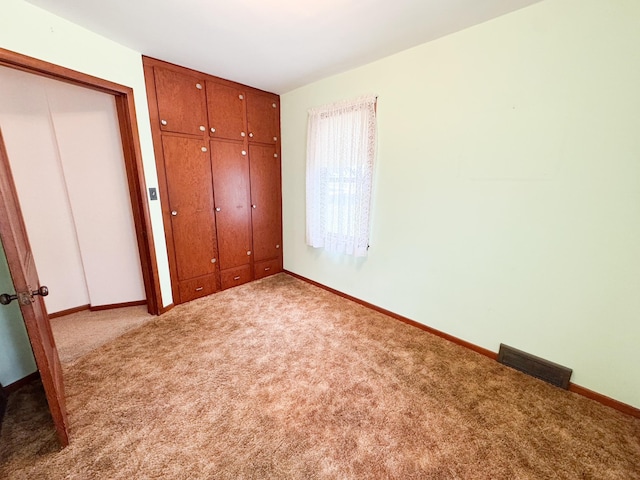 404 5th Ave, Wilmont, MN 56185 - unfurnished bedroom with carpet flooring, baseboards, and a closet