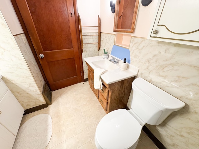 404 5th Ave, Wilmont, MN 56185 - bathroom featuring vanity, toilet, and tile walls