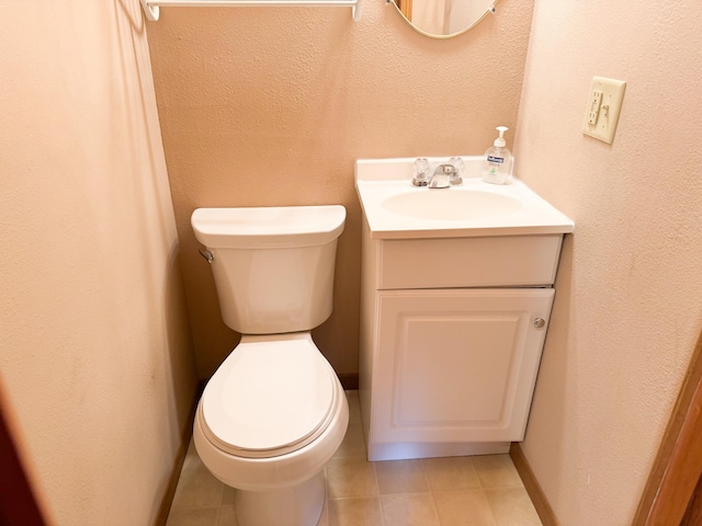 404 5th Ave, Wilmont, MN 56185 - half bath featuring toilet, vanity, a textured wall, tile patterned floors, and baseboards