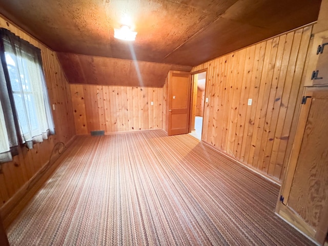 404 5th Ave, Wilmont, MN 56185 - bonus room featuring wood walls, carpet flooring, baseboards, and vaulted ceiling