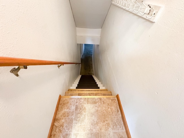 404 5th Ave, Wilmont, MN 56185 - stairway featuring baseboards and stone finish floors