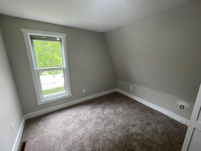 carpeted spare room featuring baseboards