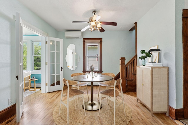1125 James Ave, Saint Paul, MN 55105 - dining area featuring a wall mounted AC, light wood finished floors, a ceiling fan, and a baseboard radiator