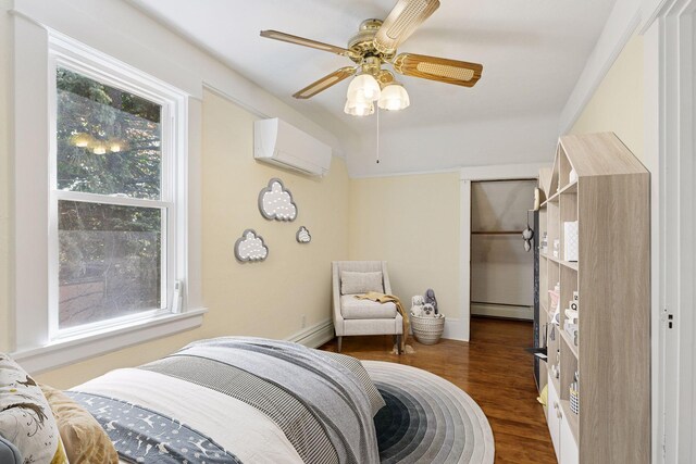 1125 James Ave, Saint Paul, MN 55105 - bedroom featuring baseboard heating, wood finished floors, a wall unit AC, baseboards, and ceiling fan