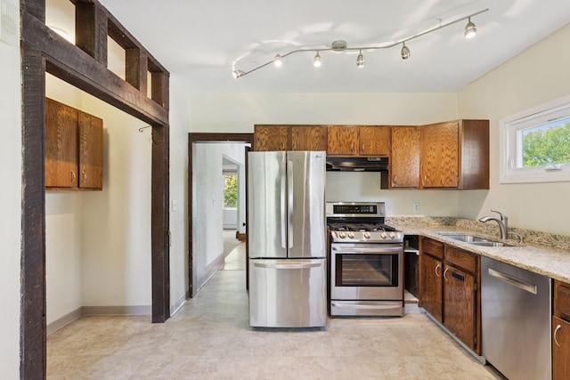 1125 James Ave, Saint Paul, MN 55105 - kitchen with stainless steel appliances, under cabinet range hood, a sink, light stone countertops, and baseboards