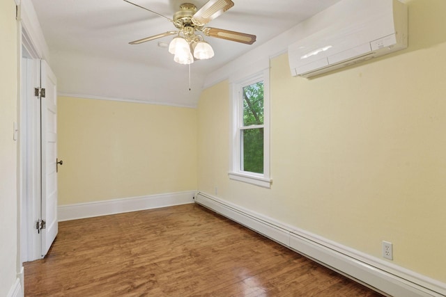 1125 James Ave, Saint Paul, MN 55105 - unfurnished room featuring baseboard heating, a wall mounted air conditioner, wood finished floors, and baseboards