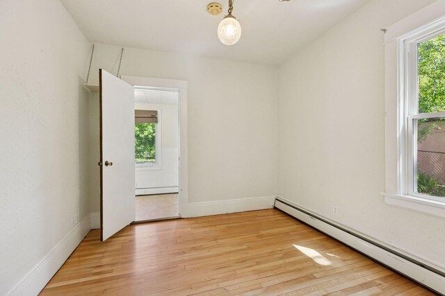 1125 James Ave, Saint Paul, MN 55105 - empty room with a baseboard heating unit, light wood-style floors, a smoke detector, and baseboards