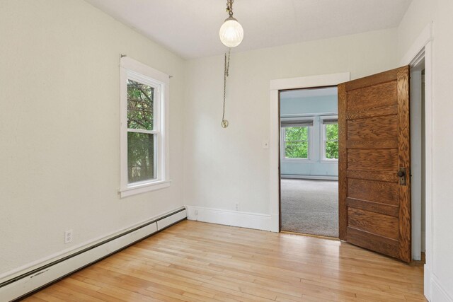 1125 James Ave, Saint Paul, MN 55105 - unfurnished room featuring a baseboard heating unit, light wood finished floors, and baseboards