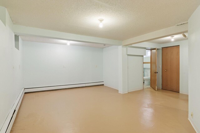 1125 James Ave, Saint Paul, MN 55105 - finished below grade area featuring a baseboard radiator, a textured ceiling, and baseboards