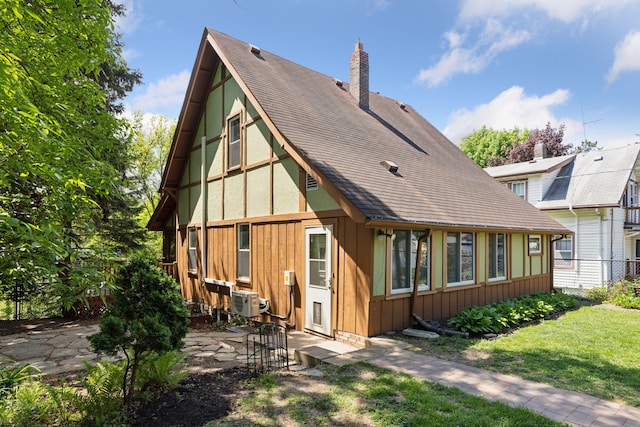 1125 James Ave, Saint Paul, MN 55105 - back of property with a chimney, a patio area, and roof with shingles