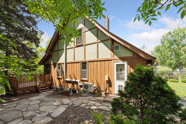 1125 James Ave, Saint Paul, MN 55105 - rear view of property featuring a wooden deck, a chimney, a cooling unit, and a patio