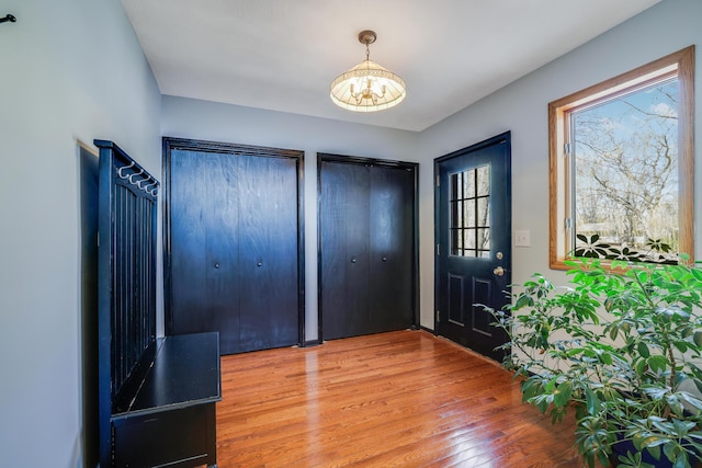 8678 Boiling Springs Ln, Shakopee, MN 55379 - foyer entrance featuring a chandelier and wood finished floors