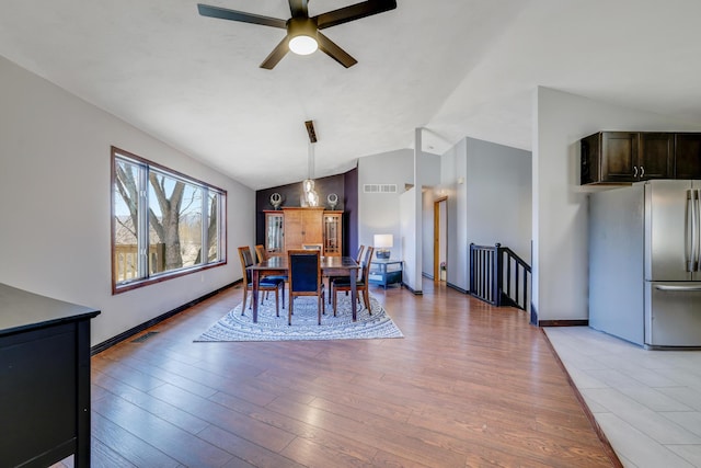 8678 Boiling Springs Ln, Shakopee, MN 55379 - dining space with lofted ceiling, a ceiling fan, and light wood finished floors