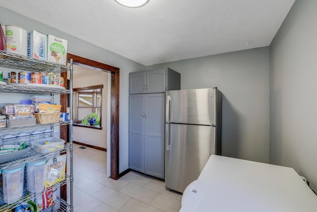 8678 Boiling Springs Ln, Shakopee, MN 55379 - kitchen featuring freestanding refrigerator, gray cabinets, light tile patterned flooring, and fridge