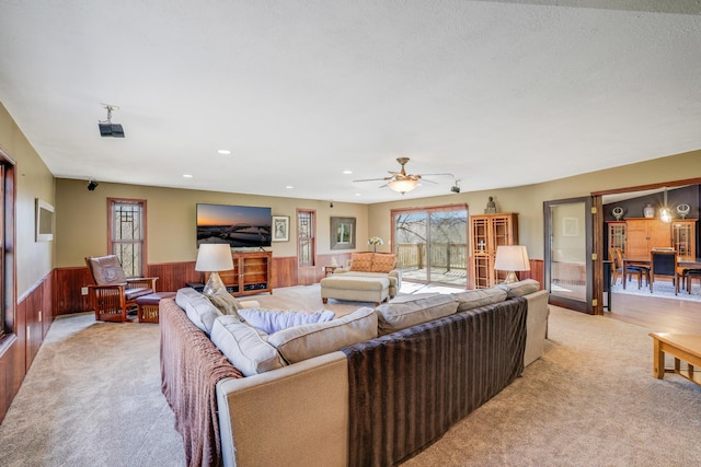 8678 Boiling Springs Ln, Shakopee, MN 55379 - living room with a wainscoted wall, plenty of natural light, light colored carpet, recessed lighting, and ceiling fan