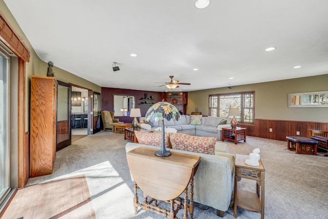 8678 Boiling Springs Ln, Shakopee, MN 55379 - living area featuring light colored carpet, wainscoting, recessed lighting, ceiling fan, and wooden walls