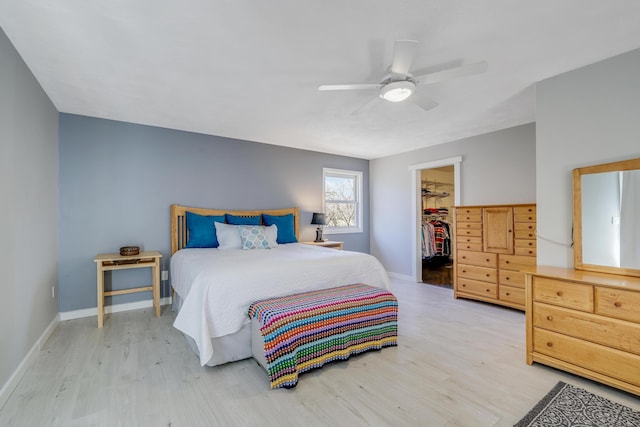 8678 Boiling Springs Ln, Shakopee, MN 55379 - bedroom featuring wood finished floors, a walk in closet, a closet, and a ceiling fan