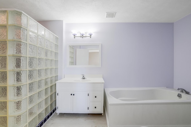 8678 Boiling Springs Ln, Shakopee, MN 55379 - full bathroom featuring vanity, a garden tub, and wood finished floors