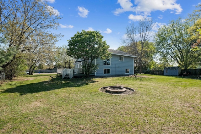 1905 125th Ave NE, Blaine, MN 55449 - view of yard with an outdoor fire pit, a storage unit, a deck, and an outbuilding