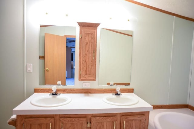 bathroom with double vanity and a tub