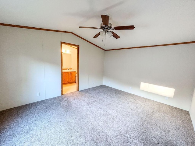 unfurnished room with lofted ceiling, a ceiling fan, carpet flooring, and ornamental molding