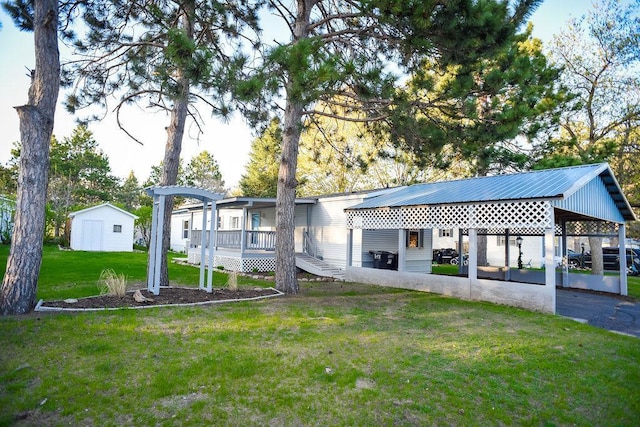 back of property featuring a yard and metal roof