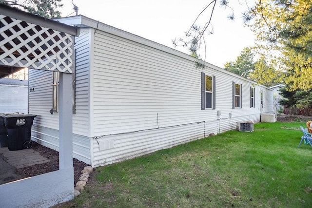 view of home's exterior featuring a yard and central air condition unit