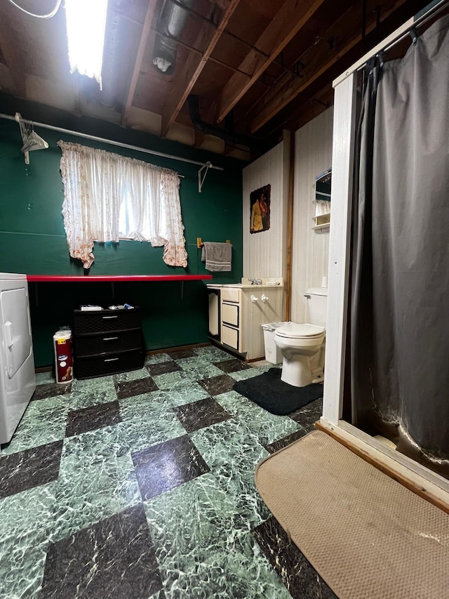 1416 13th Ave, Clarkfield, MN 56223 - bathroom featuring washer / dryer, toilet, and tile patterned floors