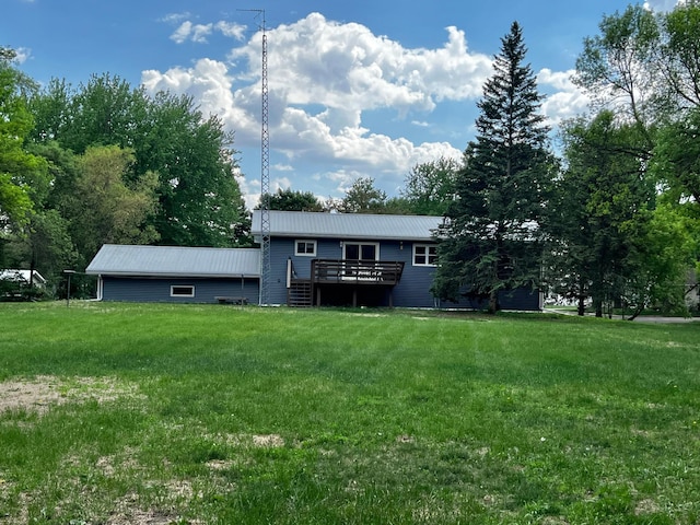 1416 13th Ave, Clarkfield, MN 56223 - rear view of house featuring a yard, metal roof, and a deck