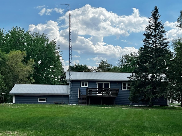 1416 13th Ave, Clarkfield, MN 56223 - rear view of house featuring a deck, a lawn, and metal roof
