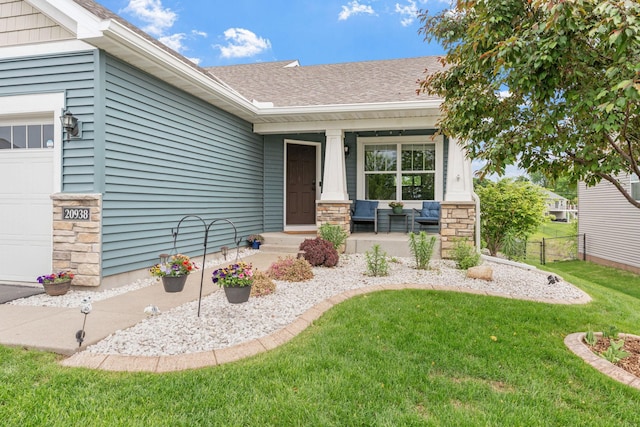 20938 Grommet Ave, Lakeville, MN 55044 - entrance to property with covered porch, a yard, roof with shingles, and stone siding