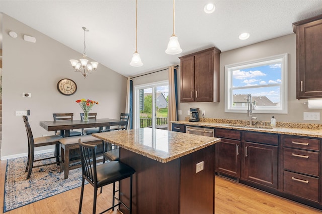 20938 Grommet Ave, Lakeville, MN 55044 - kitchen with a sink, a center island, light wood-style floors, light stone counters, and vaulted ceiling