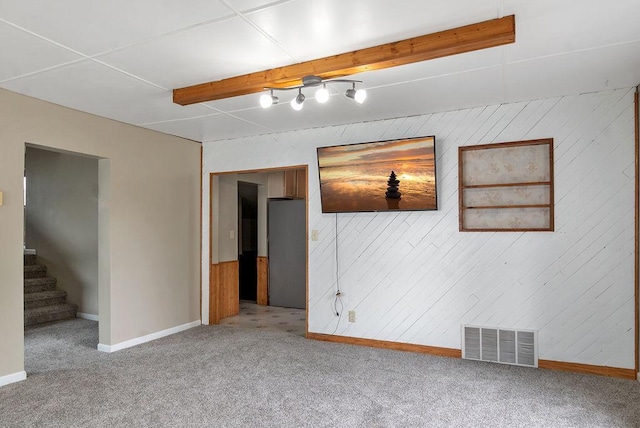 435 6th St, Cloquet, MN 55720 - carpeted empty room featuring baseboards, wooden walls, and stairway