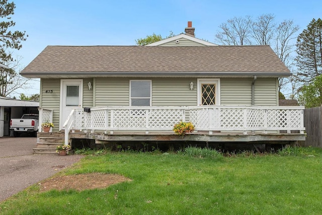 435 6th St, Cloquet, MN 55720 - back of property with roof with shingles, a deck, and a lawn
