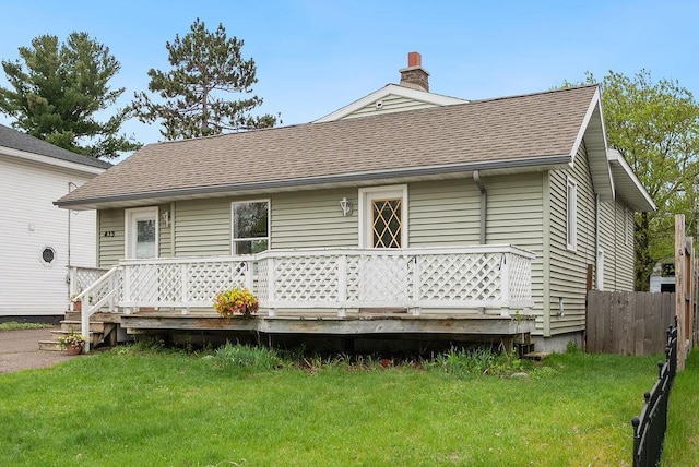 435 6th St, Cloquet, MN 55720 - rear view of property with roof with shingles, a wooden deck, and a chimney