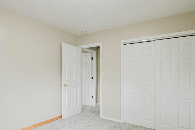 435 6th St, Cloquet, MN 55720 - unfurnished bedroom with light colored carpet, baseboards, and a closet