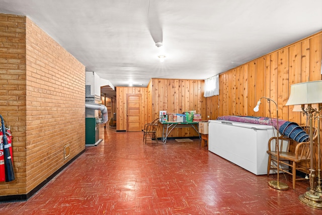 21895 County Road 8, Bovey, MN 55709 - living room with tile patterned floors, wood walls, and brick wall