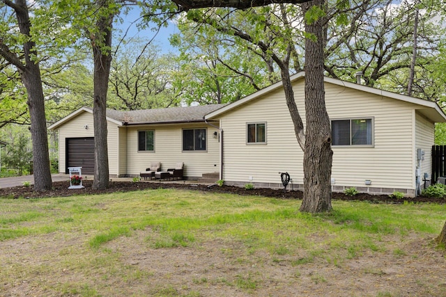 6242 Pecan St, North Branch, MN 55056 - rear view of property featuring a garage, a lawn, and driveway
