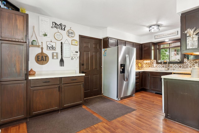 6242 Pecan St, North Branch, MN 55056 - kitchen featuring stainless steel fridge with ice dispenser, a sink, wood finished floors, light countertops, and dark brown cabinetry